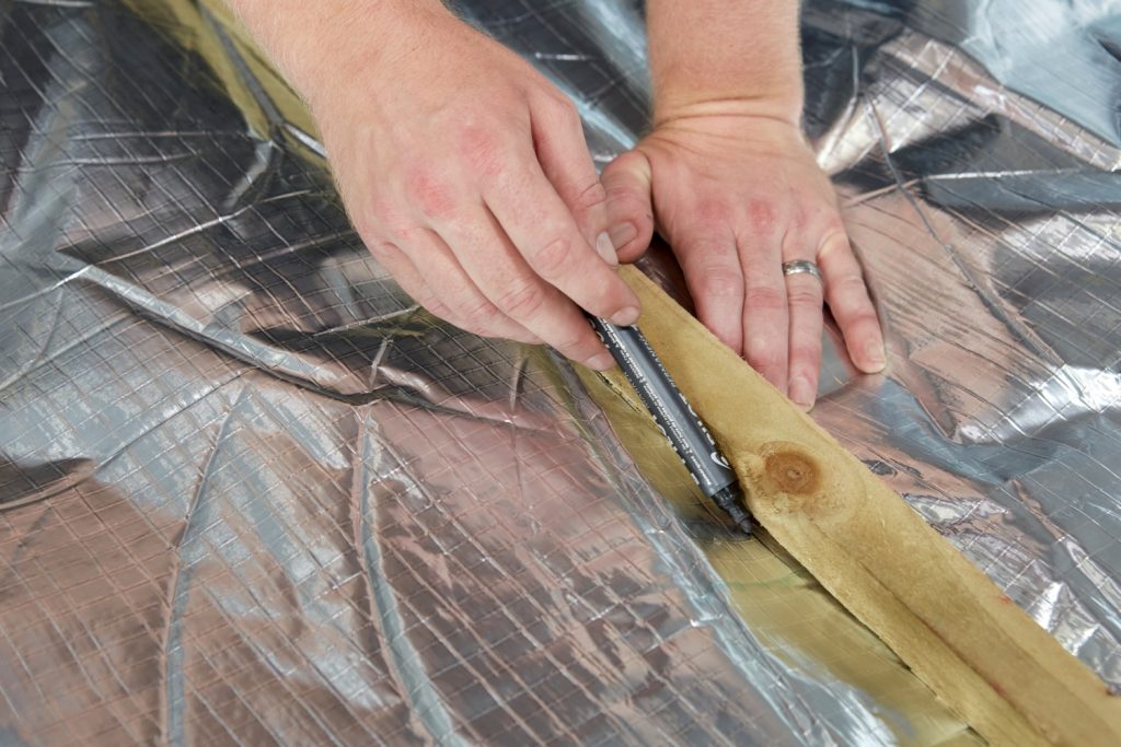 Installer carefully cuts YBS Insulation