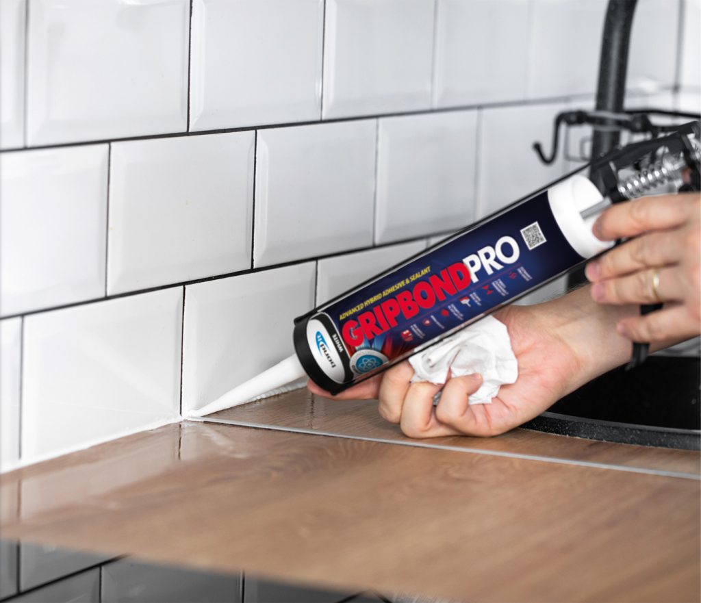 Worker uses Gripbond Pro to seal kitchen tiles