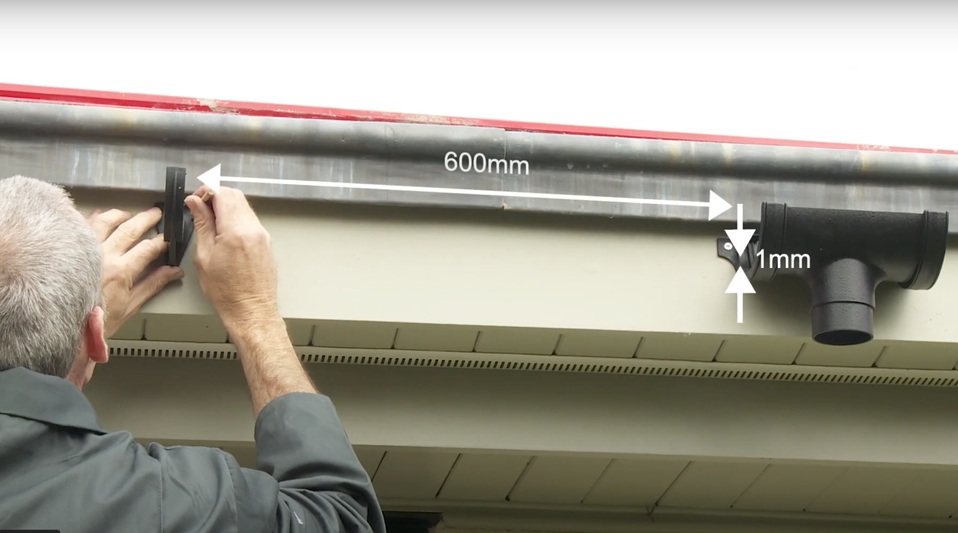 Roofer calculates guttering fall for installation