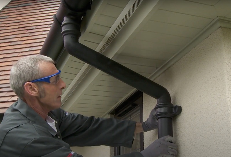 Worker fits Brett Martin rainwater system downpipe