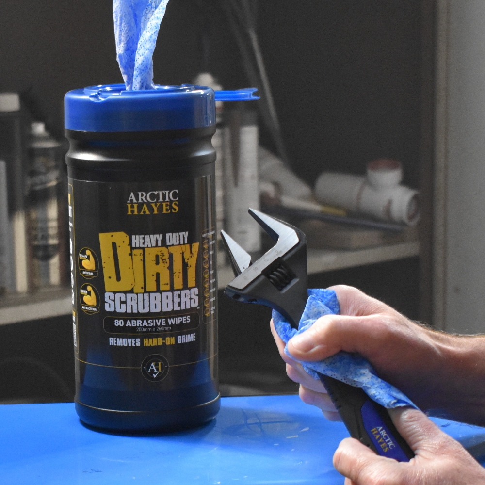 Worker uses Arctic Hayes Dirty Scrubber wipes to clean spanner