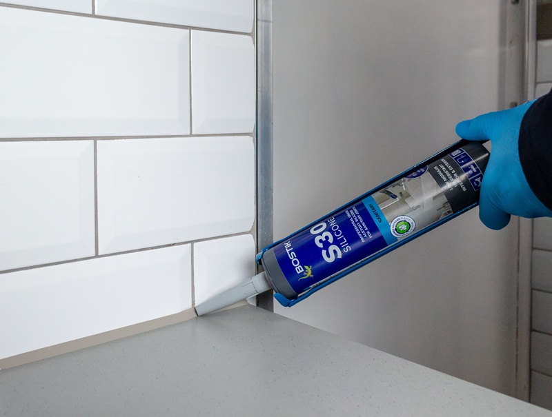Image shows worker using Bostik S30 sealant