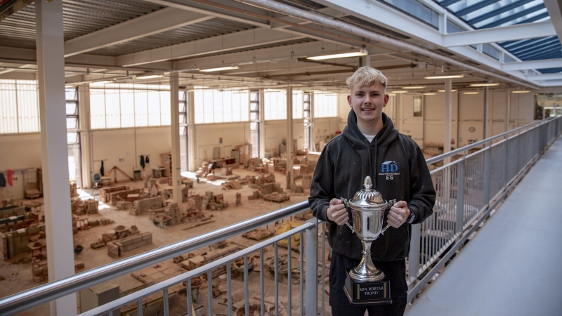 Leeds College of Building apprentice Ellis Smith with the 2025 Guild of Bricklayers trophy