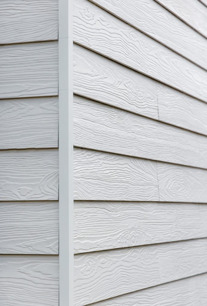 Domestic building clad in Marley's white fibre cement cladding