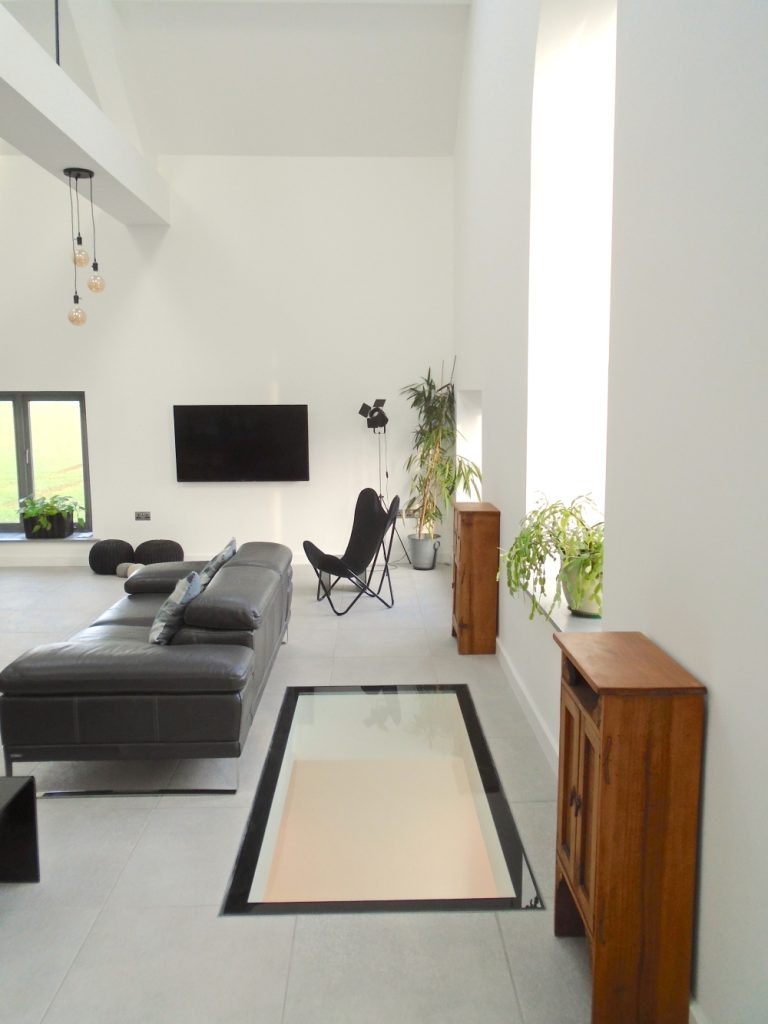 Living area with floor glazing using TuffX glass