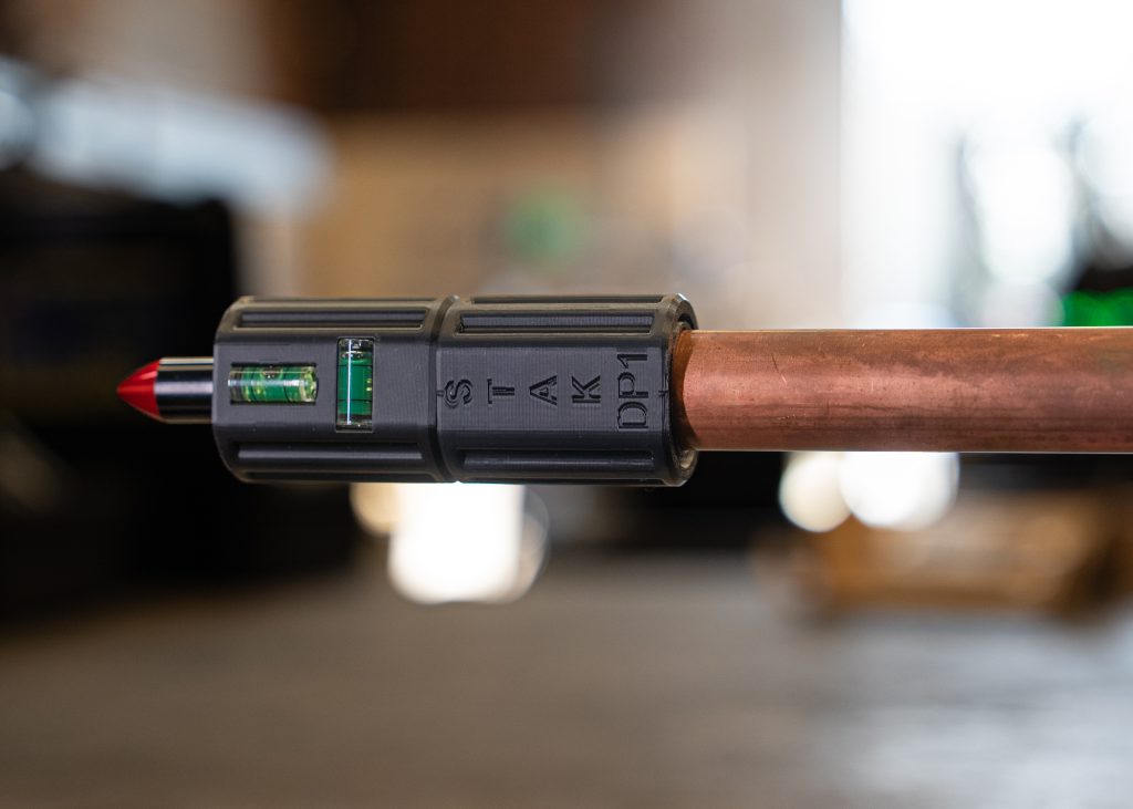 STAK laser marking tool mounted on a cooper pipe