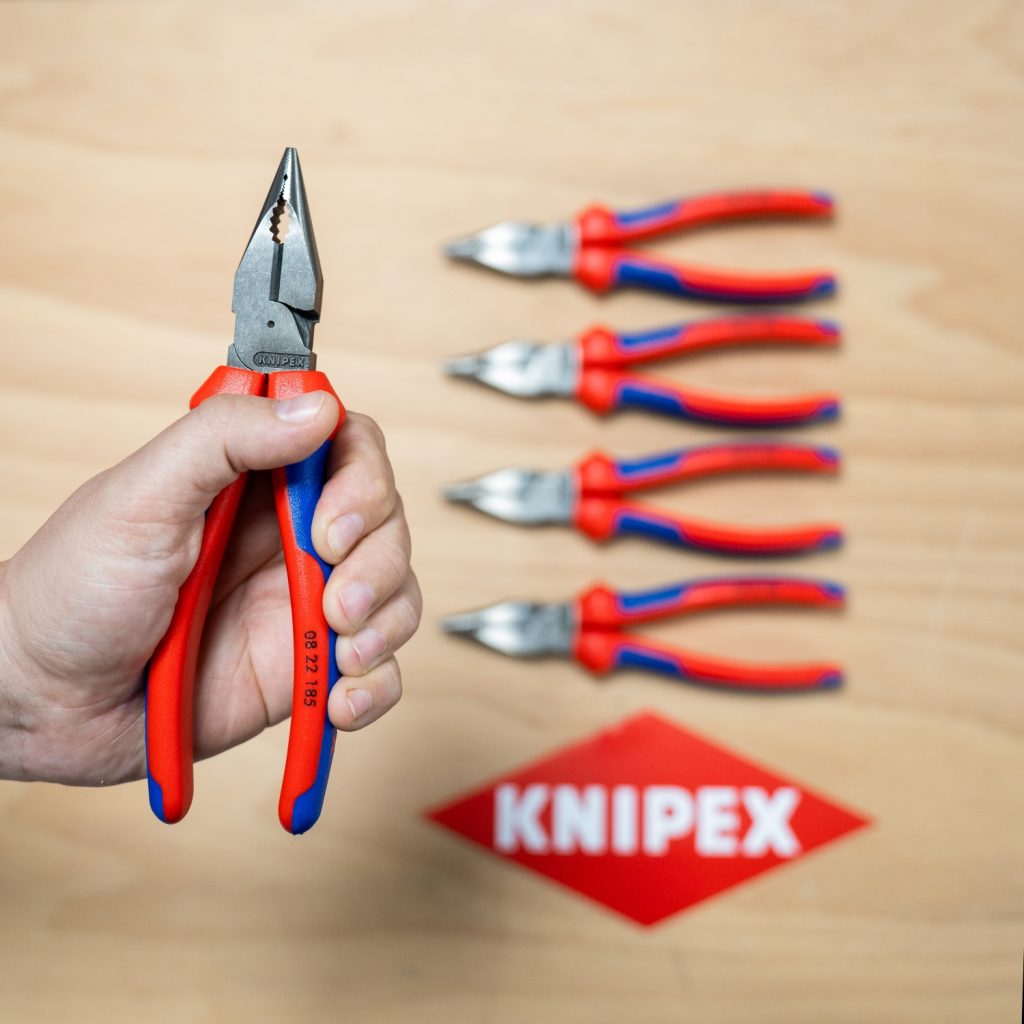 Hand holding a pair of Knipex Needle Nose Combi pliers