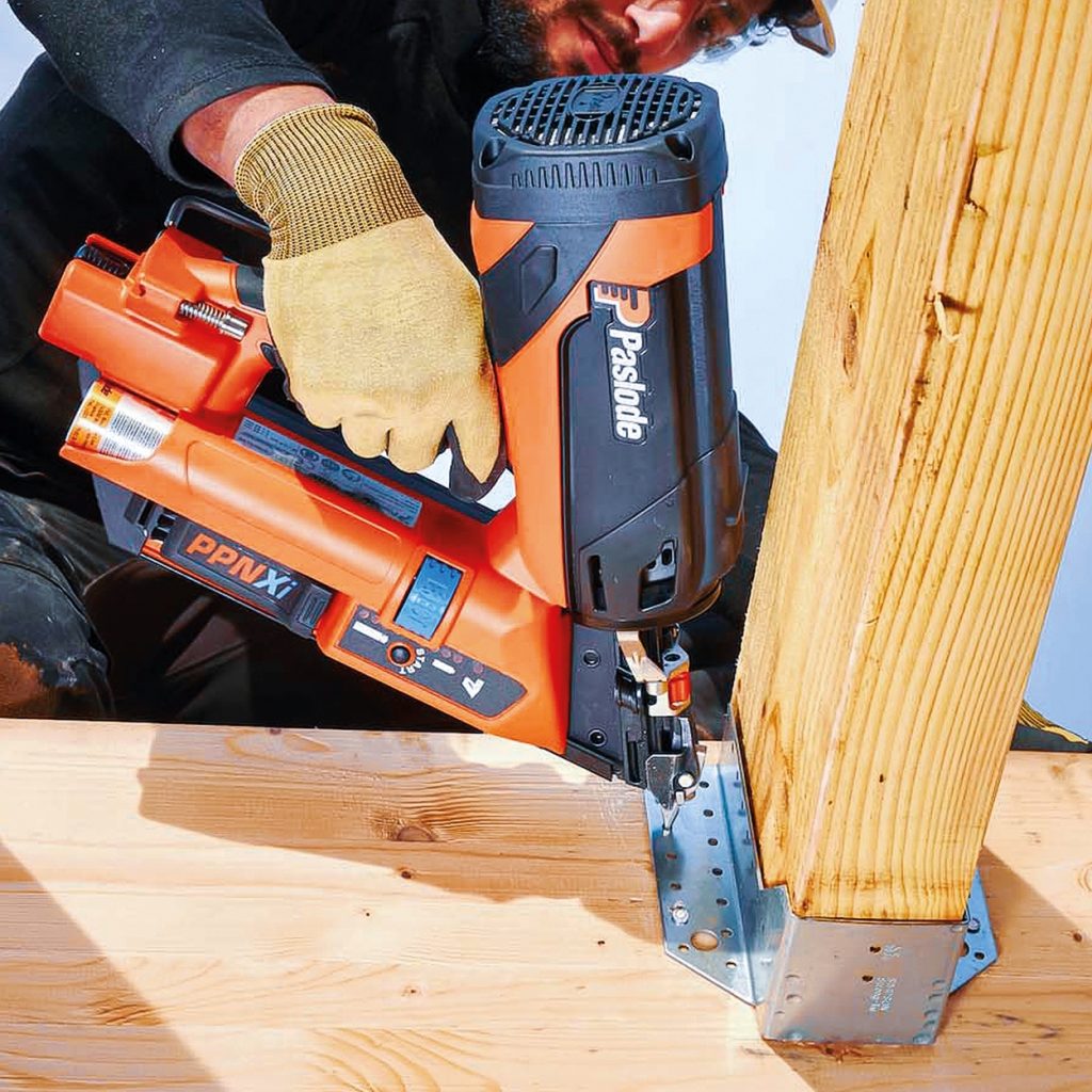 Worker uses Paslode PPN Xi nailer on timber frame