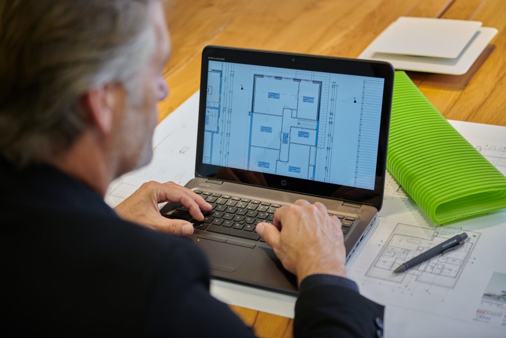 Image shows man on laptop planning a MVHR system