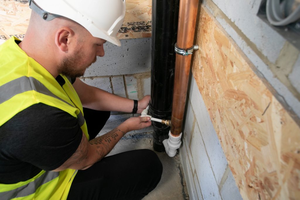 Installer undertakes a Showersave installation